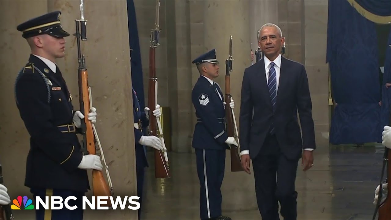 Obama and Clintons draw boos from Trump supporters watching from parade arena