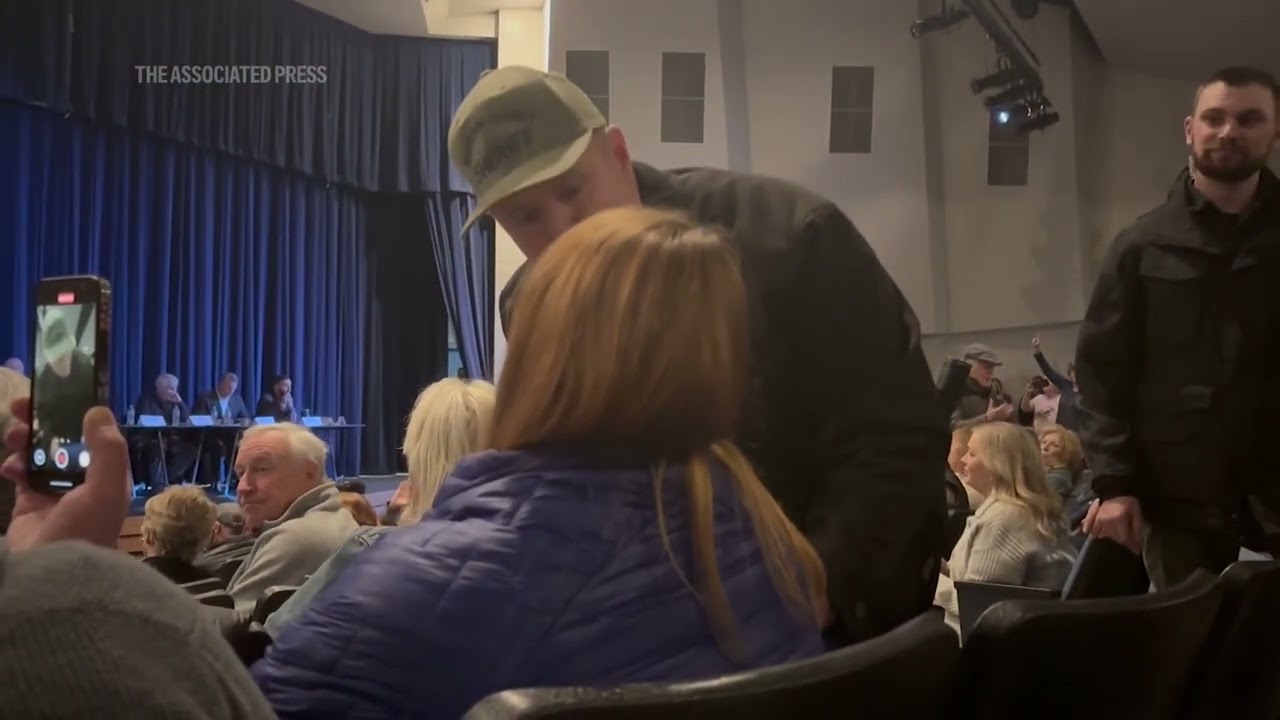 Idaho town hall meeting turns chaotic after woman is forcibly removed for shouting at speakers