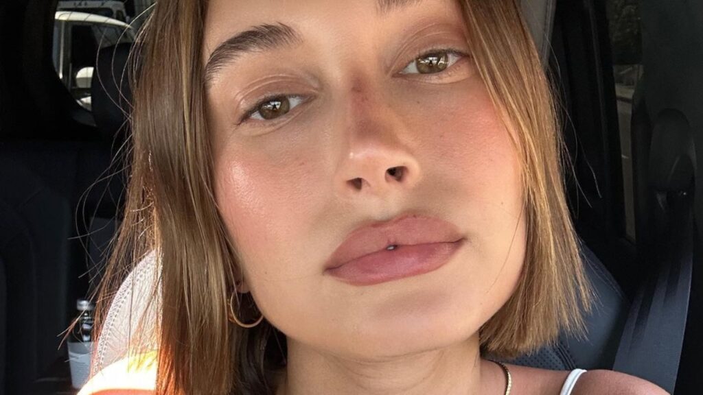 Hailey Bieber natural skin in car photo