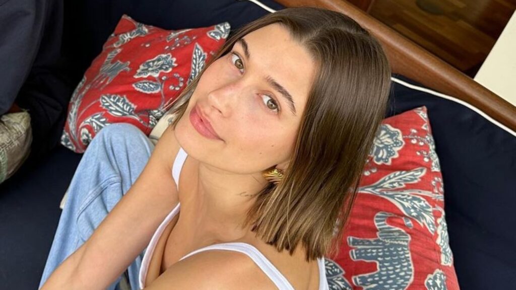 Hailey Bieber cosies up on a couch