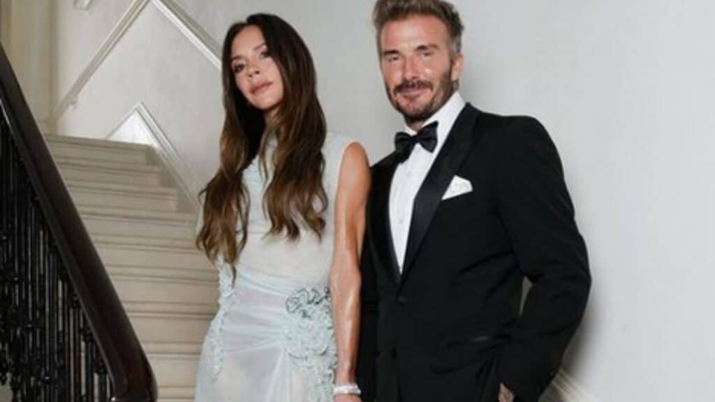 David and Victoria Beckham Marital Problems Revealed in Bombshell Book Victoria and David Beckham hold hands while posing together on a staircase.