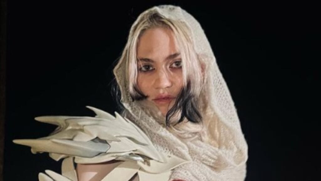 Elon Musk Pleaded to ‘Honor Agreement’ & Dying Wish of Grime’s Grandmother Grimes poses in futuristic outfit