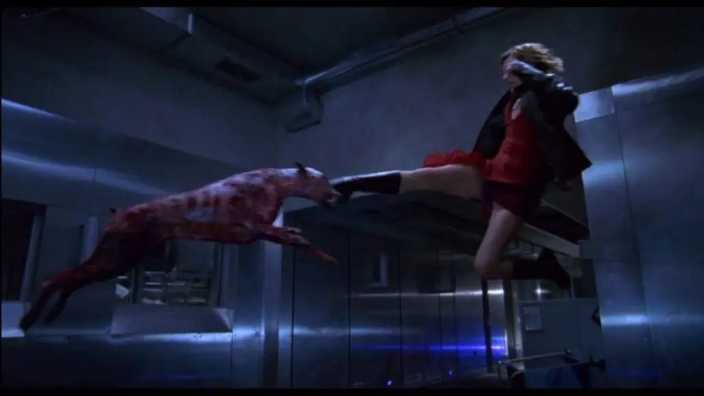 A shot of Milla Jovovich kicking a zombie dog from Resident Evil