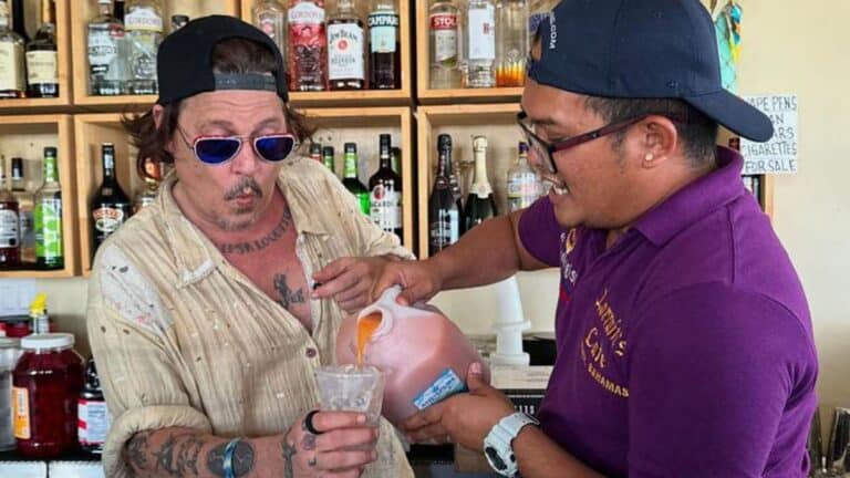 Johnny Depp pours a drink with local bartender in The Bahamas