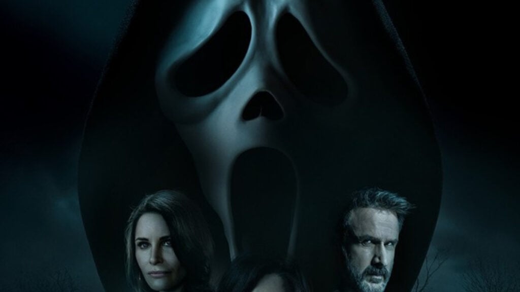 A close-up of Ghostface's mask and two characters from the film