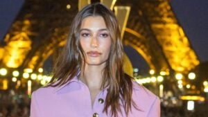 Hailey Bieber poses in lavender dress