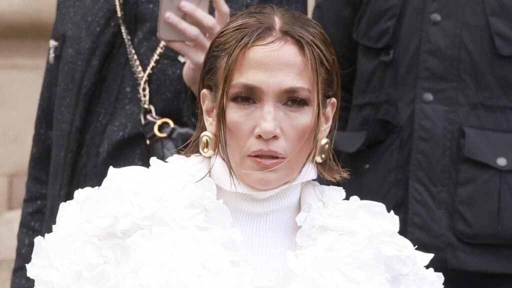 Jennifer Lopez poses with short hair and white coat