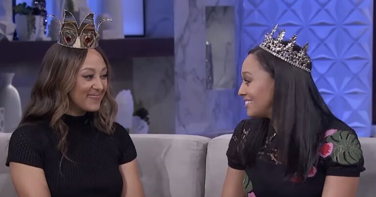 Tia Mowry Boasts About ‘Beautiful Connection’ With Sister Tamera Tia and Tamera Mowry sitting on a couch with crowns on their heads.