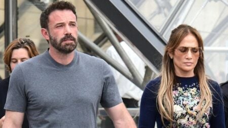 Ben Affleck and Jennifer Lopez holding hands.