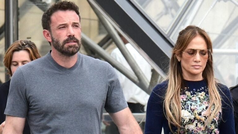 Ben Affleck and Jennifer Lopez holding hands.