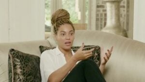 Beyoncé sitting on a couch during an interview.