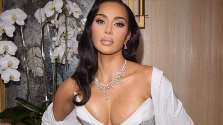 Kim Kardashian Under Fire Following Disturbing ‘Hook Up’ With Elon Musk’s Tesla Robot: ‘I Hate This For Mankind’ Kim Kardashian in a white dress.