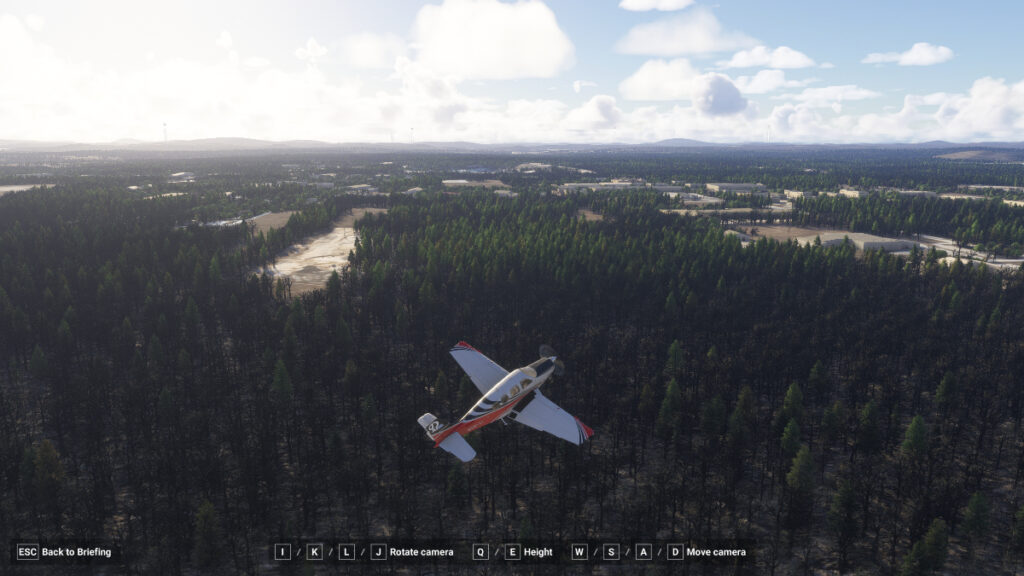 A bush plane flies over a rural runway