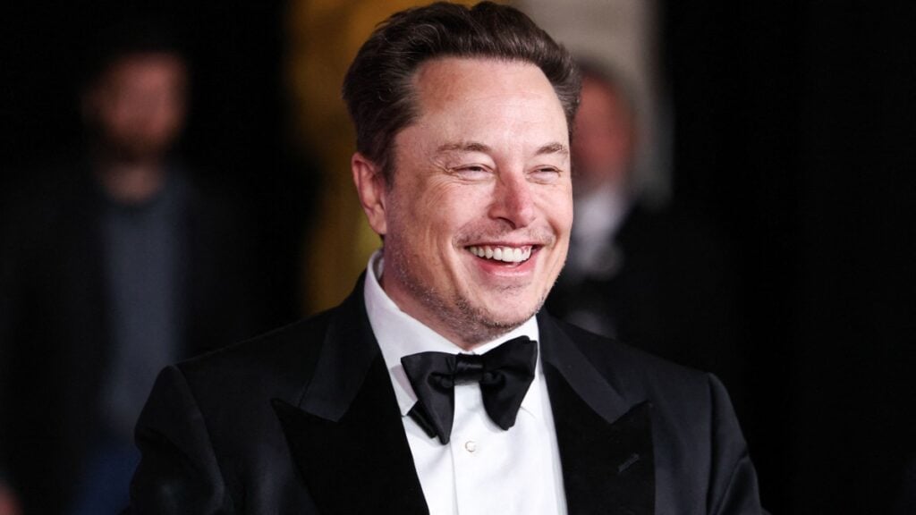 Elon Musk in a black suit