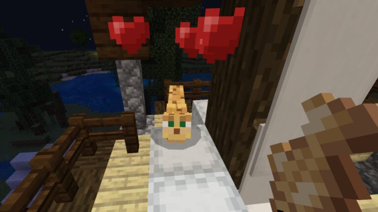 How To Tame an Ocelot in Minecraft An ocelot with hearts floating above its head in Minecraft
