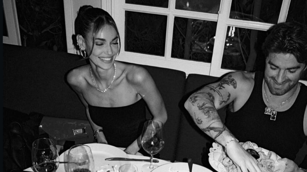 A black-and-white photo of The Chainsmokers DJ Drew Taggart having dinner with fiancée Mari Fonsec