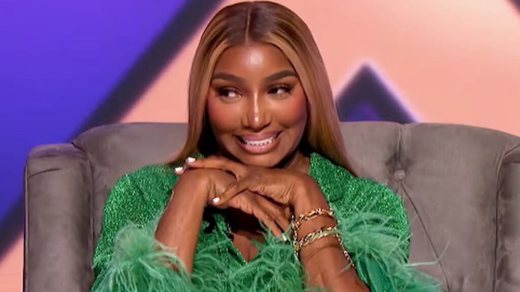Fans React to NeNe Leakes Saying She and Bravo Are ‘Dating Slowly’ Amid Real Housewives of Atlanta Return Rumors NeNe Leakes in a green outfit sitting in a chair smiling.