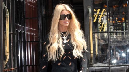 Jessica Simpson smiling and wearing sunglasses