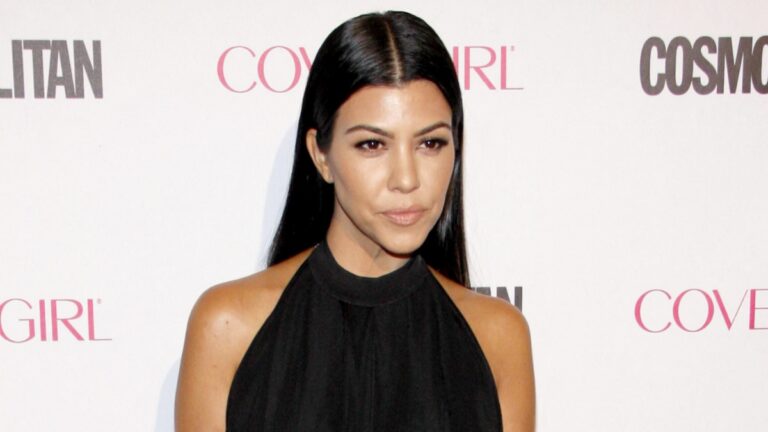 Kourtney Kardashian poses at an event.