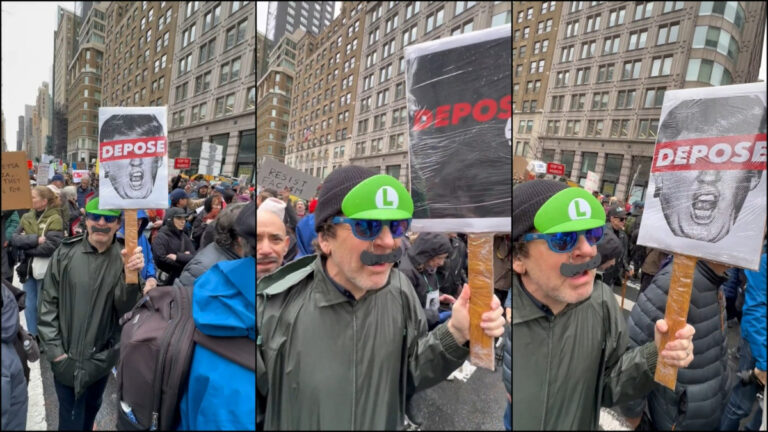 A man in a Luigi hat at an NYC protest holds a sign with Trump and Musk on it, saying "Depose"