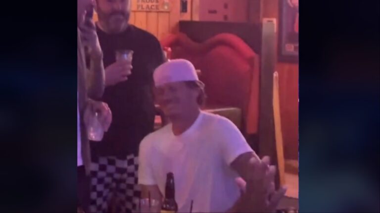 Tom DeLonge watches a fan preform his song in a California bar