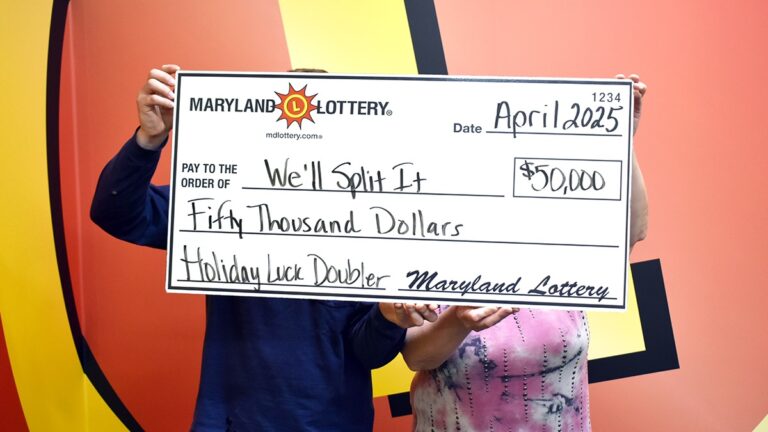 Mom and Son Find Lost Fortune in Maryland Worth $50,000, ‘Did That Really Just Happen?’ a mother and son holding a giant check with their lottery win written on the front