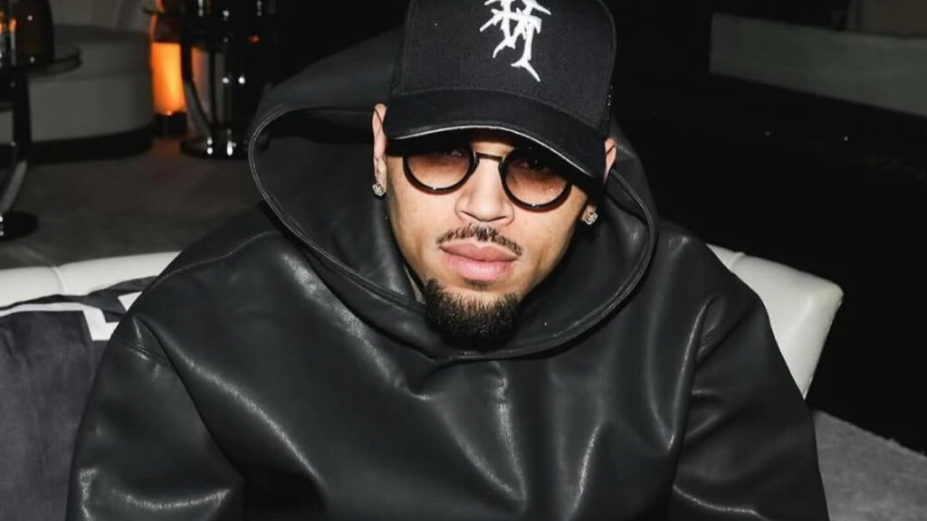 Photo of Chris Brown in an all-black ensemble.