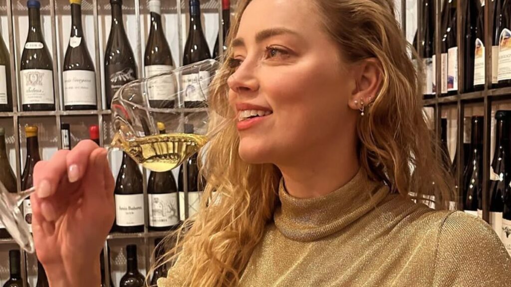 ‘Toxic’ Amber Heard Returns To Acting, But Fans Aren’t Having It: ‘Dreadful Actress’ Amber Heard sipping wine