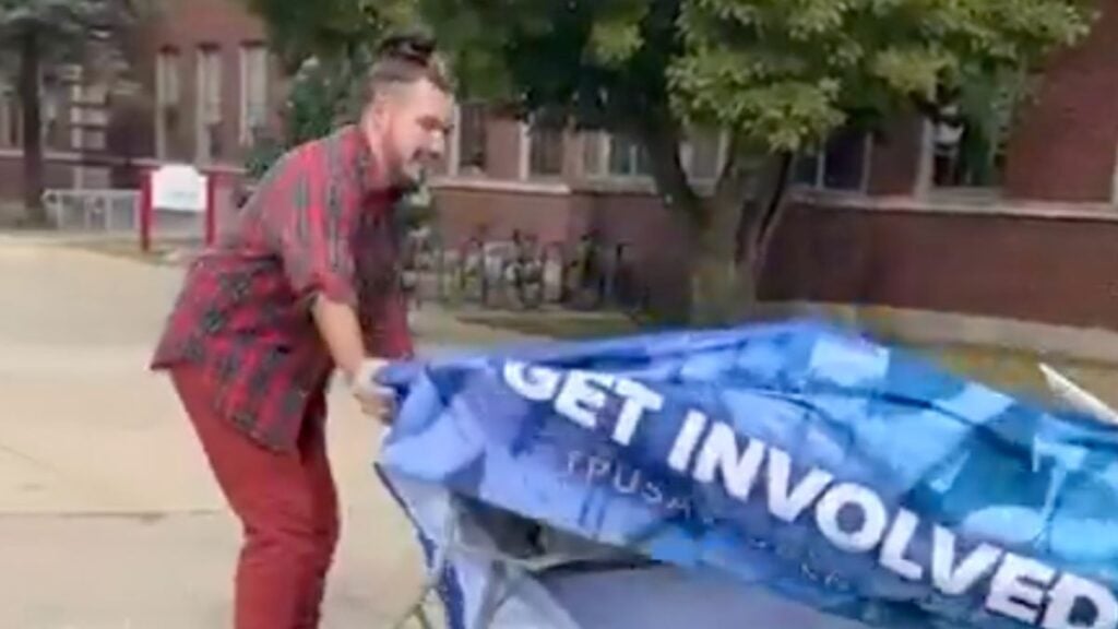 Illinois teacher's assistant destroying Turning Point USA table