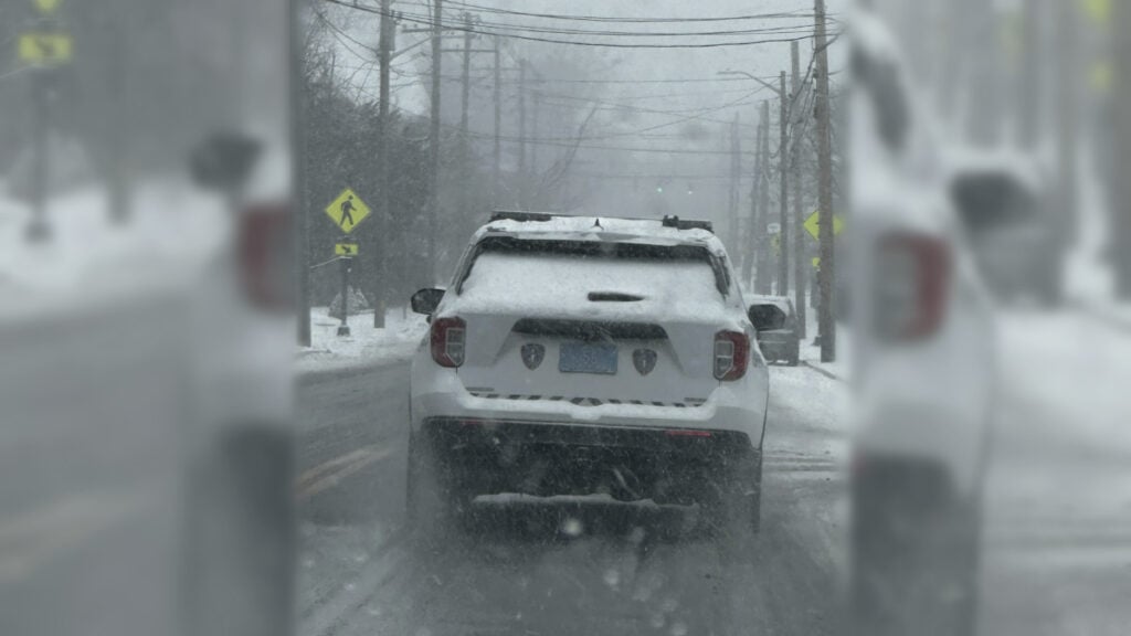 Police Car Driving Without a Care in the World Through Blizzard